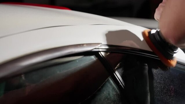 Close-up of a Man's Hands Polishing Car Roof with Electric Buffer in Auto Body Shop