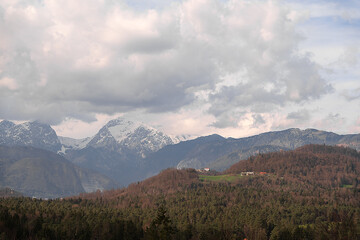 landscape with clouds and snowy Alps