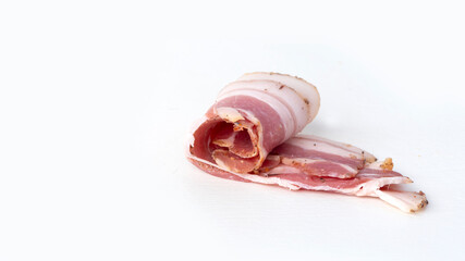 Thin slices of spicy pork bacon on a white background
