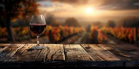 Fotobehang Wood table top with a glass of red wine on blurred vineyard landscape background © Ricardo Costa