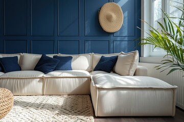 Beige corner sofa in room with dark blue walls. Interior design of modern living room.