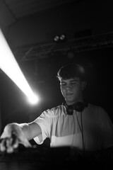 Monochrome photo of a DJ playing on a nightclub