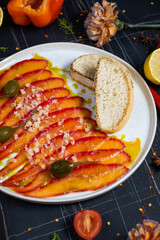 Salmon carpaccio in a white plate on a wooden table