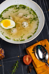 Fresh homemade chicken soup with noodle at table. Black background. Top view. Copy space