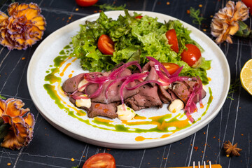 Saltimbocca alla Romana with salad and fried potatoes