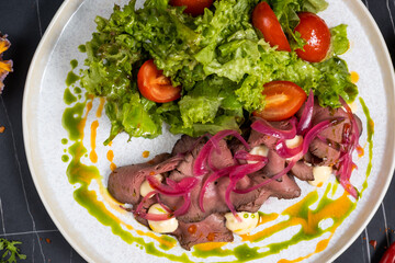 Saltimbocca alla Romana with salad and fried potatoes