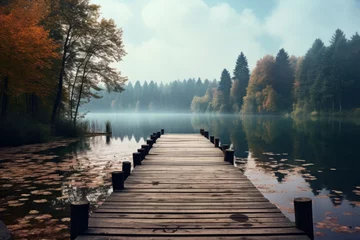 Gartenposter Charming wooden pier extending into a calm lake surrounded by nature © KerXing