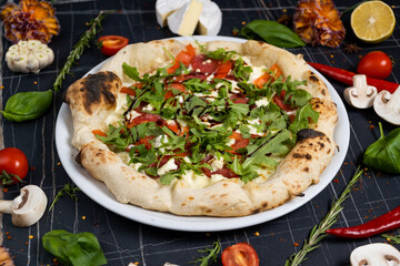 Salmon and arugula pizza. Light and tasty restaurant meal for a foodie