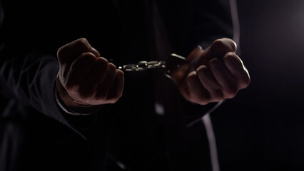 Businessman in handcuffs concept of illegal business