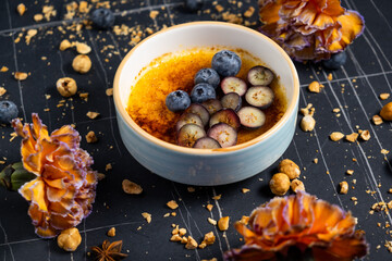 Cr?me br?l?e, creme brule. Classic creme brul? being flamb?. Burning, flaming, ramekins, vanilla beans, blowtorch, sugar