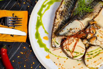 baked mackerel fish in a pan with lemon herbs and spices, banner, menu recipe place for text, top...