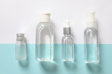 Various transparent bottles on a colored background