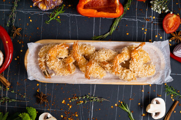 Fried Shrimps tempura with sweet chili sauce on black board stone