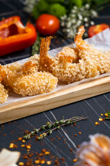 Obraz na płótnie Canvas Fried Shrimps tempura with sweet chili sauce on black board stone