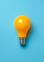Bright Orange Light Bulb on Vibrant Blue Background, Conceptual Creativity