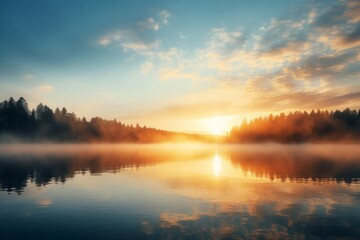 Fototapeta premium Sunrise sky background over a calm lake with mist rising