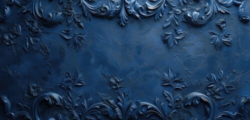 Intricate decorative design on a textured navy blue stucco wall. Wide-angle view, rough surface. Coral background.
