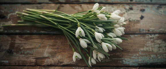 A cluster of white flowers arranged neatly on a wooden table