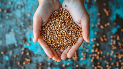 A person holds a handful of buckwheat seeds in their hands, showcasing the nutritious and versatile ingredient - Powered by Adobe