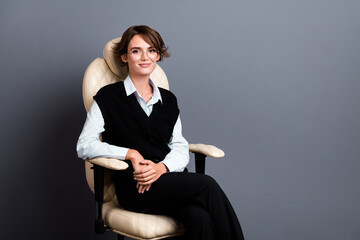Photo of successful woman with bob hairdo wear black waistcoat in glasses sit on armchair in office...