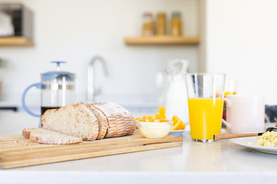 A breakfast spread awaits on a kitchen counter