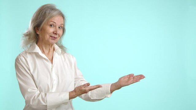 Businesswoman in white displaying hand gestures, pointing to an empty space ideal for advertisement or custom text placement, set against a minimalist light blue background. Camera 8K RAW. 