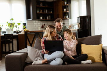 Family Bonding Time With Laptop in Cozy Home Setting - 763446869
