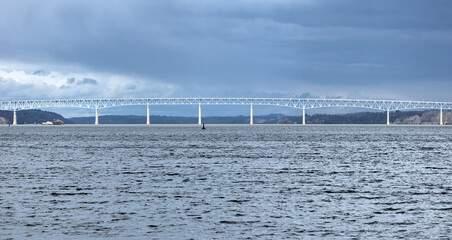 view of the Kingston-Rhinecliff Bridge from Kingston point beach (continuous under deck truss toll bridge across hudson river in new york state)