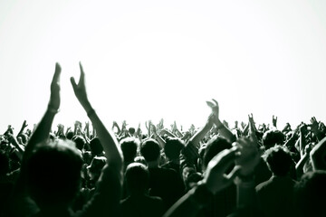 Crowd cheering and watching a band on stage, blurred motion, shallow DOF.