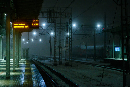 Railway station at night during snowfall