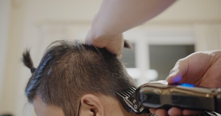 A man is cutting a man's hair