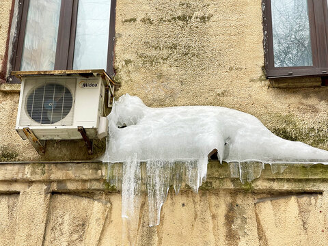 Moscow, Russia, March, 10, 2024. Ice and icicles on the wall of house 8 on Shchepkin Street from the courtyard. Moscow