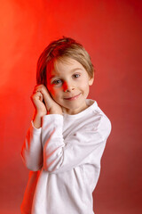 Artistic portrait of a child, boy, lightened with gel filters, studio shot