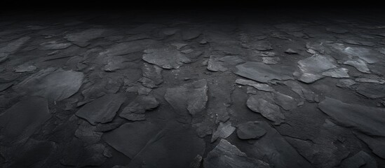 Dark rugged rock texture on black background