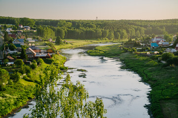 Rustic Village Scene: River and Hanging Bridge