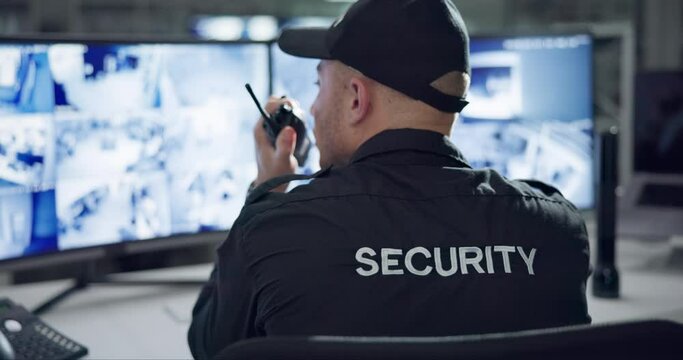 Security guard, computer screen and cctv surveillance on radio for inspection service and building safety with rear view. Control room, officer and man with walkie talkie in data center with talking