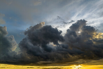 Colofrul clouds brightly illuninated by setting sun on evening sky. Changing cloudscape weather at sunset