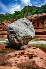 A giant gray boulder sits at the edge of Oak Creek at Slide Rock State Park near Sedona Arizona - 763484694