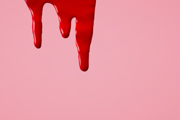 Blood on pink background. First menstrual period concept, menstruation cycle period