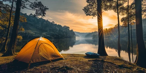 Tuinposter Yellow camp tent in front of beautiful lake in the forest with sun going up © AnaV