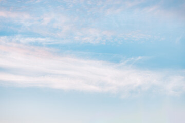 A beautiful sky tinted by the sun leaving vibrant shades of gold, pink, blue and multicolored. Clouds in the twilight evening and morning sky. Cloudy sky background in the evening and during the day.