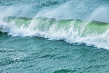 Wave splashing close-up. Crystal clear sea water, in the ocean in San Francisco Bay, blue water, pastel colors.