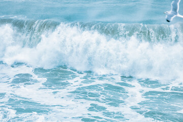 Wave splashing close-up. Crystal clear sea water, in the ocean in San Francisco Bay, blue water, pastel colors.