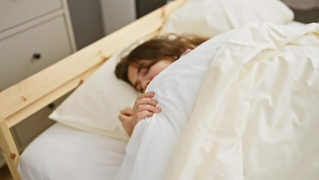 A young woman sleeps peacefully in a cozy bedroom, highlighting tranquility and comfort at home.