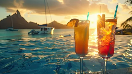  two colorful cocktails in tall glasses on the edge of an infinity pool with an orange and red drink. Colorful sky over the islands with sailboats and tropical palm trees moored nearby. © Светлана Канунникова