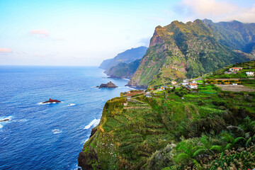 View of the Pico do Alto towering above the north coast of Madeira island (Portugal) in the Atlantic Ocean from the Bom Jesus viewpoint in Ponta Delgada