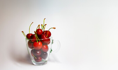 Red cherries with stems on glass bowl, natural light. - 763504823