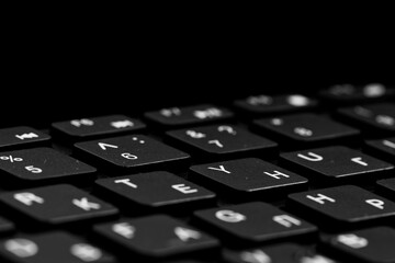 Close up view of  black keys. Black PC keyboard on a black background. English and cyrillic...