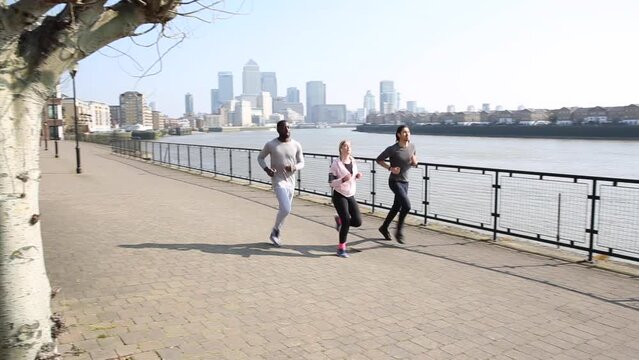 Multiracial group of friends with men and women running together