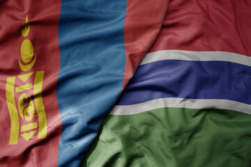 big waving national colorful flag of gambia and national flag of mongolia.